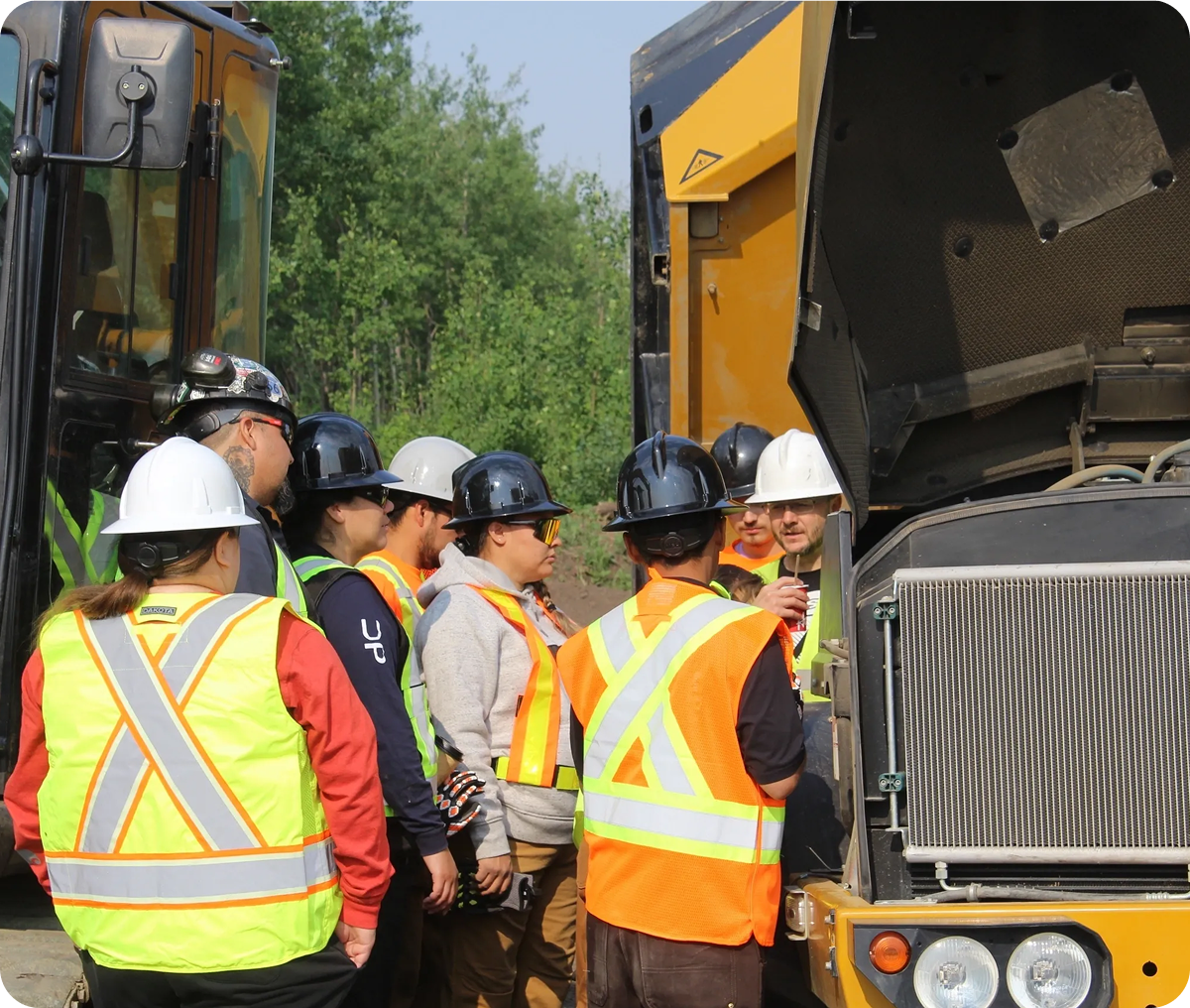 Group examines construction vehicle outdoors