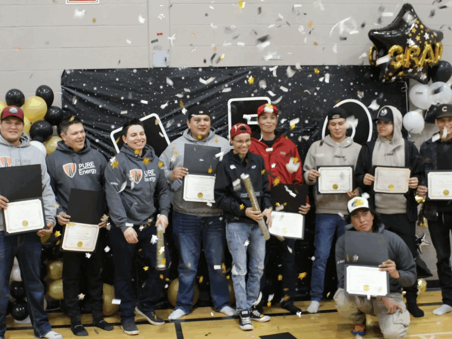 Graduation ceremony with certificates and balloons