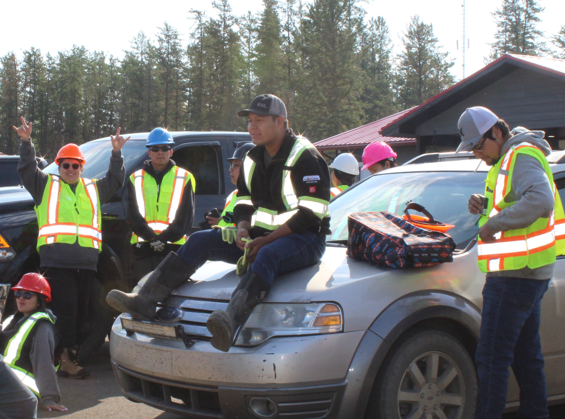 Emergency responders gathered around a vehicle at a scene.