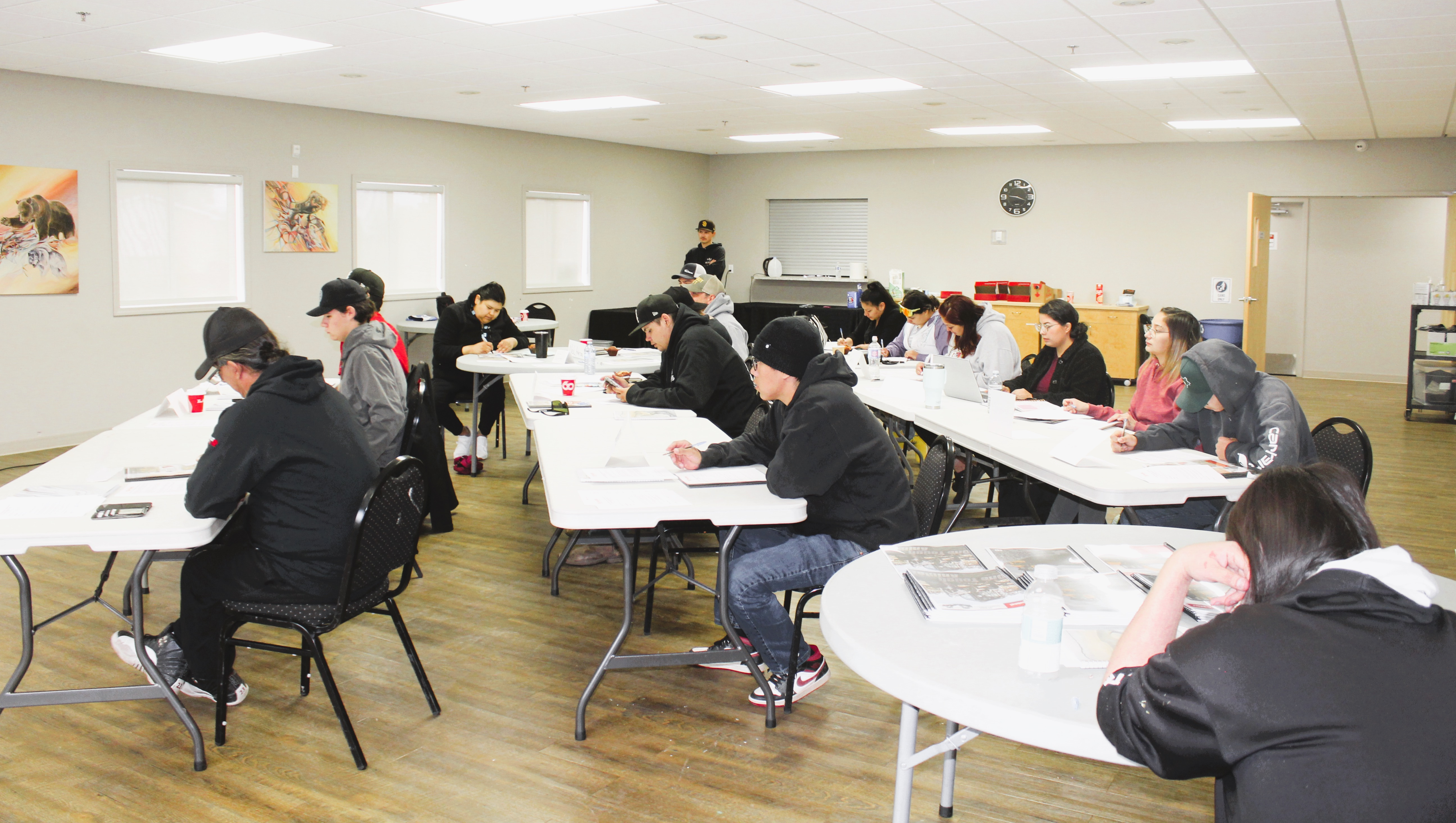 Students in a classroom attentively working on assignments.