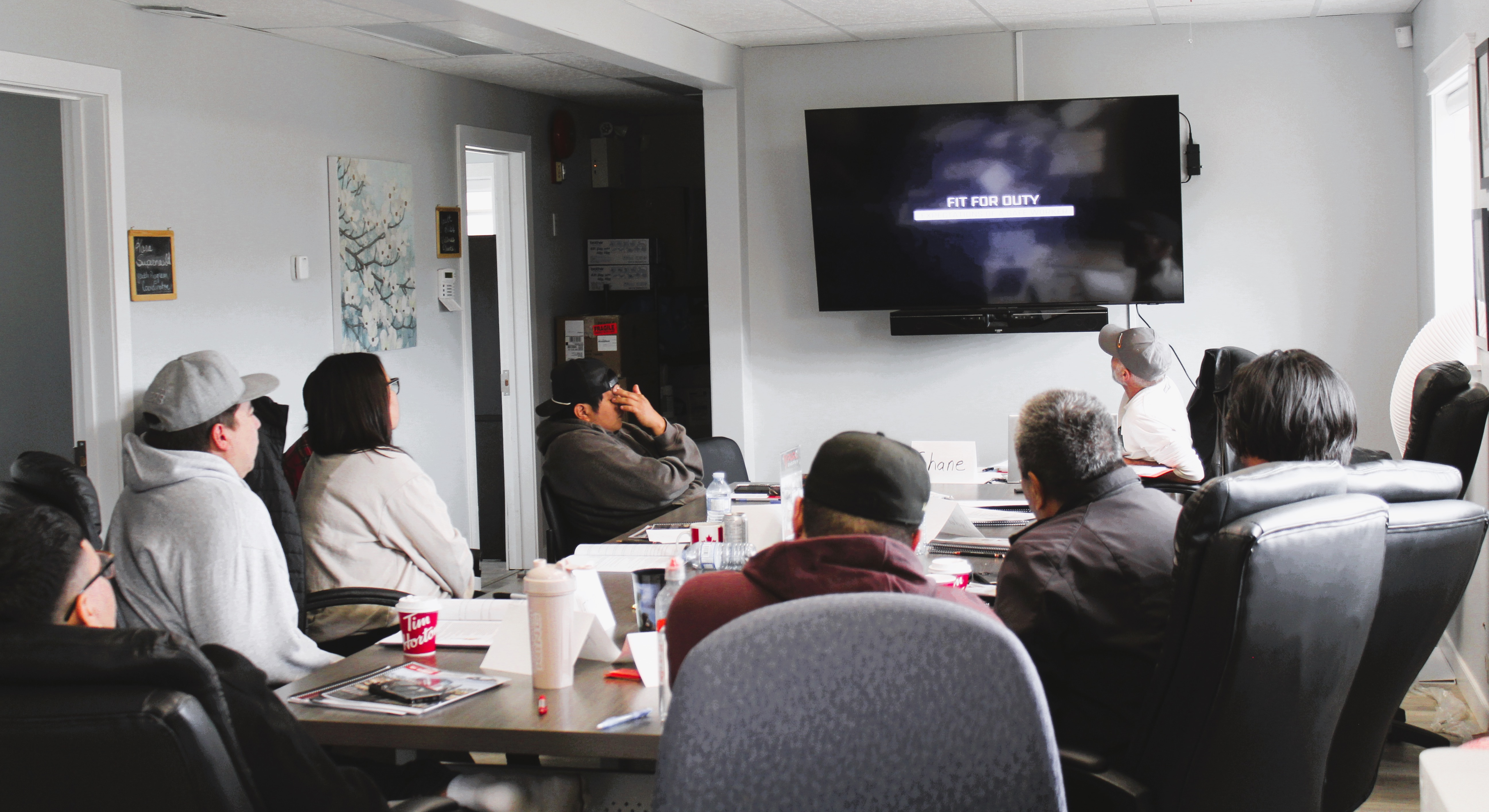 People watching a presentation in a conference room.