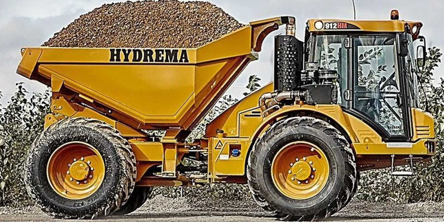 A large yellow Hydrema dump truck at a construction site.